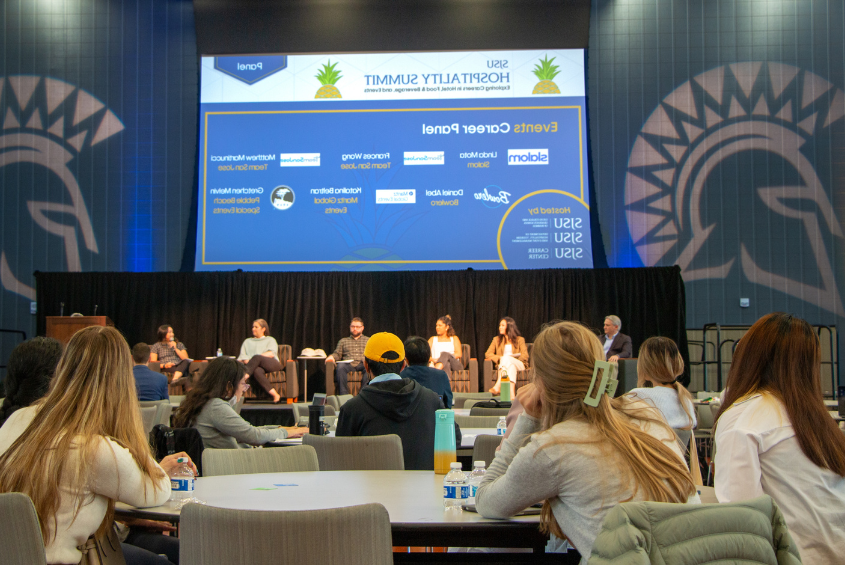 Students listen to panel at the Hospitality Summit