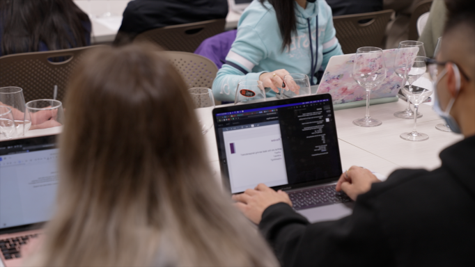 Students taking notes on laptops