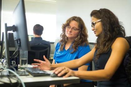 Student and advisor at a computer