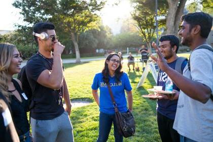 Small group of students talking at outdoor campus event