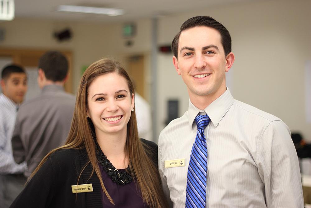 Male and female students smiling 